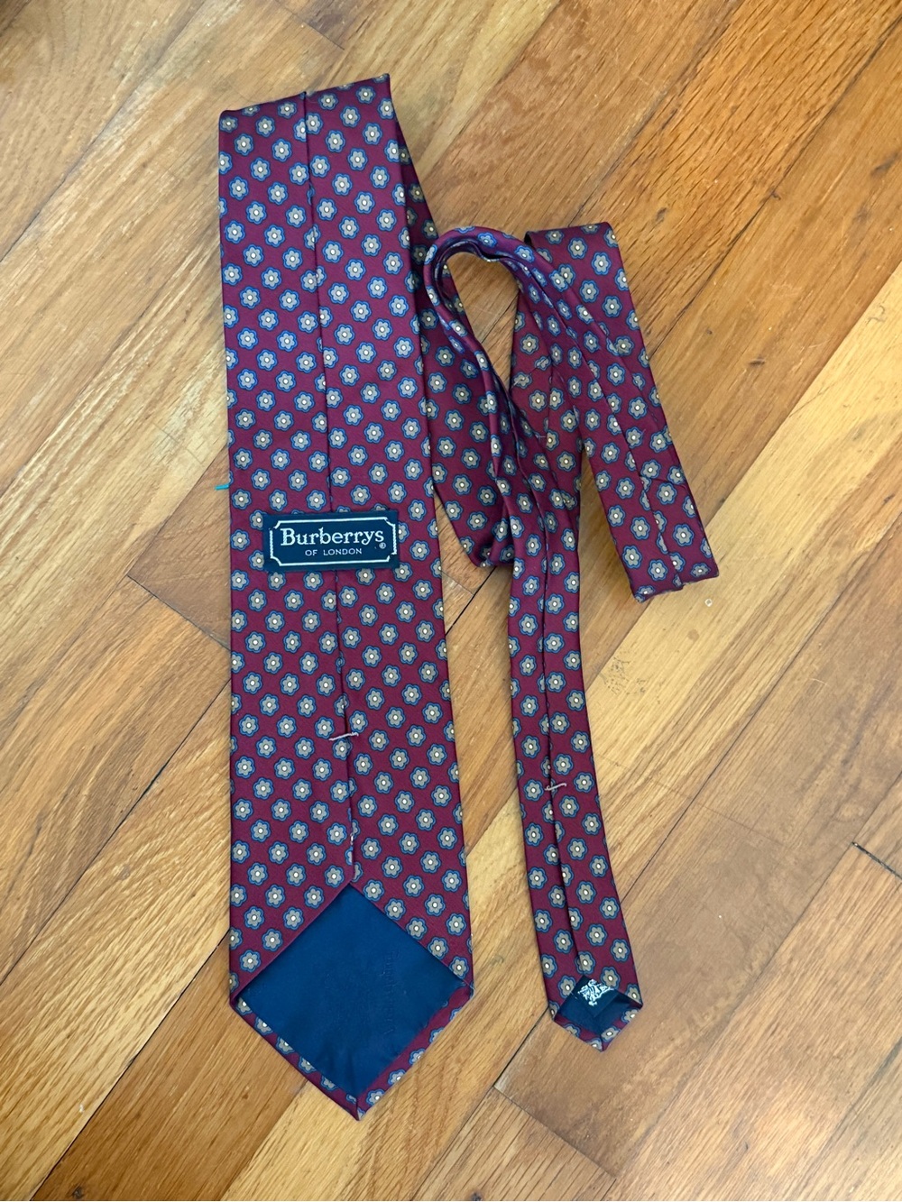 Burberrys Burgundy Silk Tie with Blue and Gold Motif